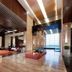 VOGO Abu Dhabi Golf Resort & Spa lobby in Abu Dhabi with seating, polished floors, and tall windows