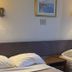 Bridgewater Hotel in Bridgewater room with two beds, wall lamps, and a framed picture