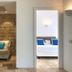 Hotel Cala Caterina in Villasimius: cozy seating area beside a bedroom with white bed and blue pillows