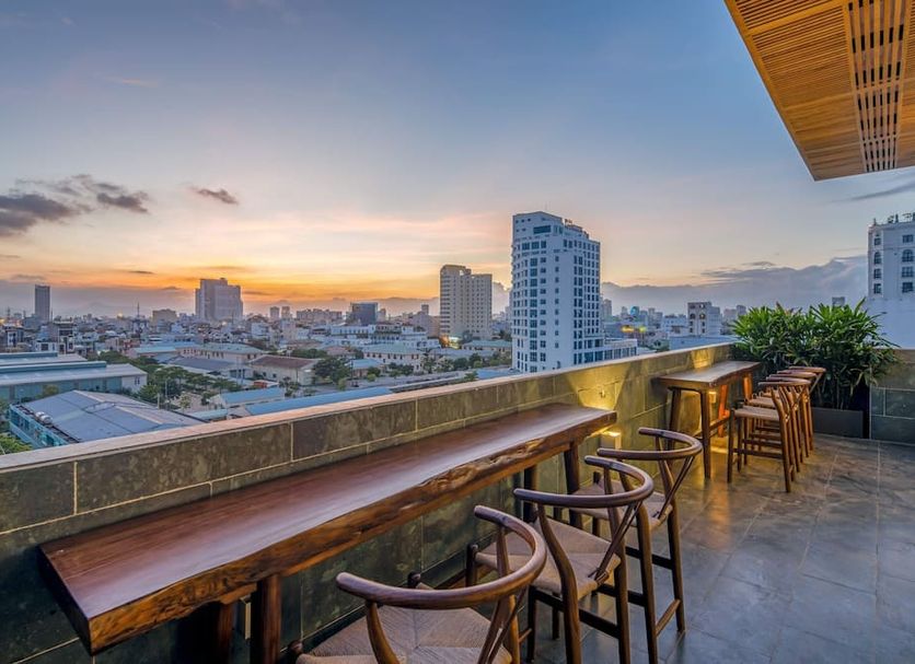 Platinum Danang Hotel in Da Nang rooftop terrace with bar seating and city sunset views