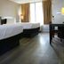 Heritage Inn & Suites by Capital O Baton Rouge I 10 room with two beds, desk and window curtains
