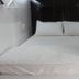Vintage Inn Boutique Capsule @ Little India Singapore capsule bed with white bedding and hanging clothes rails