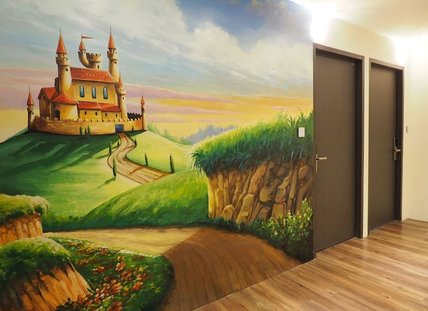 M Hotel Kaohsiung City hallway with castle mural, grassy hillside and wood-look flooring