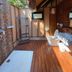 Bann Pae Cabana Hotel And Resort in Rayong, outdoor shower with wooden deck and tropical privacy screen.
