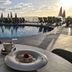 Apartamentos Sal Rossa in Sant Josep de sa Talaia: poolside breakfast with ocean-view pool at sunrise