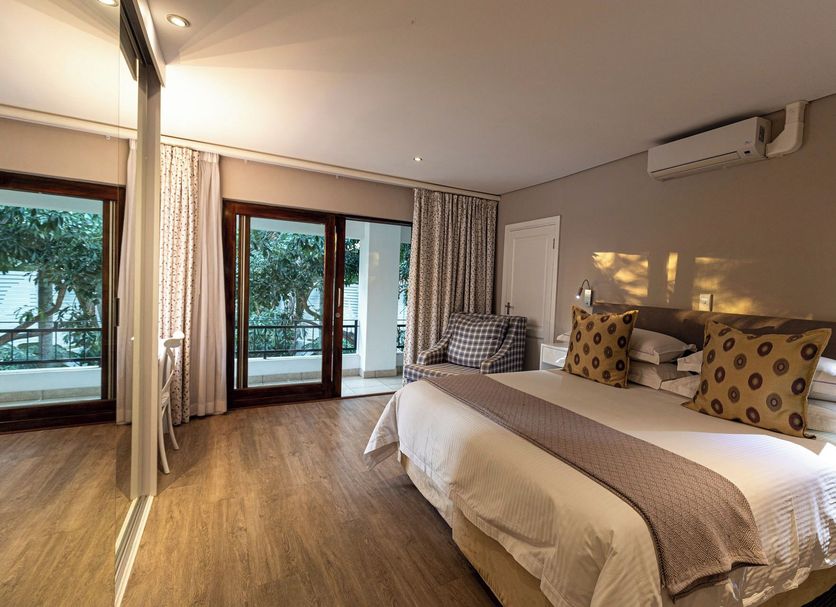 Hyde Park Guest House in Johannesburg bedroom with king bed and sliding doors to balcony