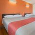 Motel 6 Fort Nelson, BC: guest room with two beds, orange accent wall and wood floor