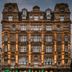Victory House London facade in London, a historic hotel with lit windows and street-level cafes