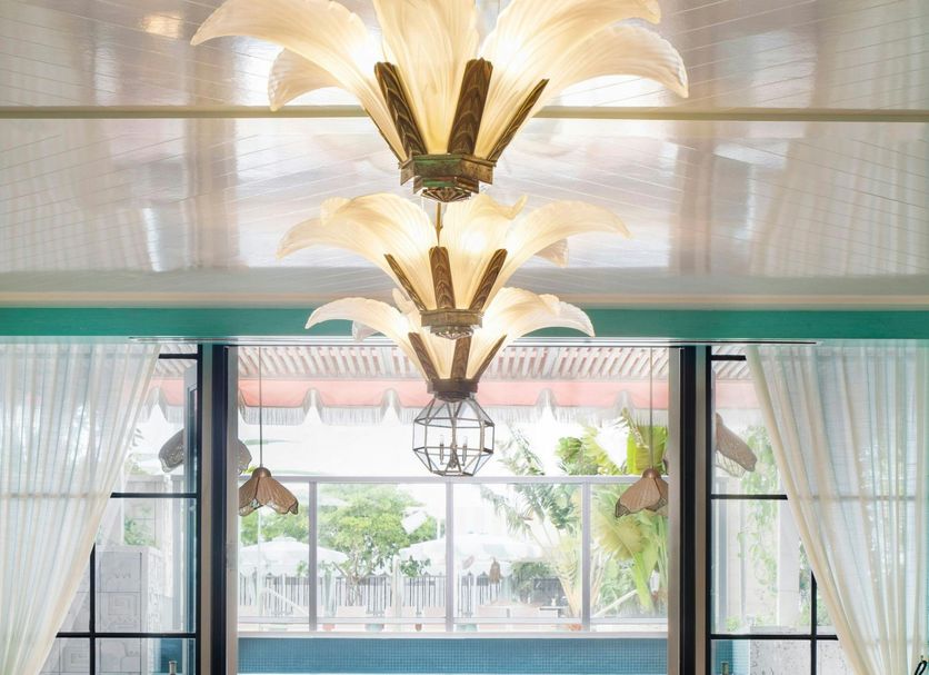 the goodtime hotel, Miami Beach lobby lounge with teal daybed, tropical decor and large windows