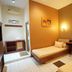 Patria Garden Hotel Blitar guest room with twin beds, desk, wall art and mirror