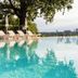 Infinity pool at Hotel & Spa Der Steirerhof in Bad Waltersdorf with loungers, trees and valley views
