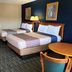 Travelodge by Wyndham Williamsburg Colonial Area room with two beds and a vanity in Williamsburg