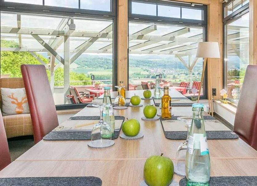 Romantik Hotel Ahrenberg dining table by large windows with scenic valley views in Bad Sooden-Allendorf