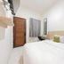 Wisma Rimadi Guest House Jakarta room with double bed, desk, wall-mounted TV and window