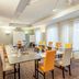 Appart'City Classic Genève - Gaillard meeting room with U-shaped conference tables and orange chairs