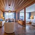Lijiang Tianyu Boutique Hotel in Lijiang suite with seating area and mountain view through large windows