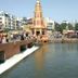 Hotel Pooja International in Nashik, riverside temple view with water flowing into a pond