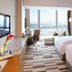 Langham Place, Xiamen guest room with twin beds, city view, and desk by floor-to-ceiling windows