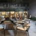 Leonardo Boutique Hotel Krakow Old Town courtyard seating area with outdoor lounge chairs and glass-front entrance