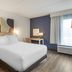 Spark by Hilton Atlanta Airport South College Park guest room with king bed and large window