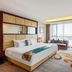 Shijiazhuang Shen Zhou 7 Star Hotel room with king bed, sofa, desk and city view through large window
