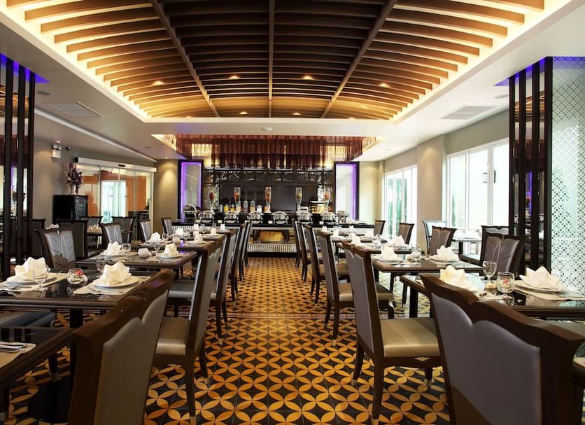 Chillax Resort Bangkok restaurant with set dining tables and warm ceiling lighting