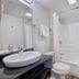 Motel 6 Chicago West - Villa Park bathroom with sink, toilet, mirror and shower-tub combo