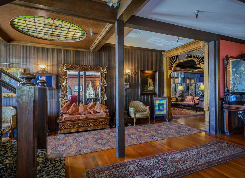 Mendocino Hotel and Garden Suites in Mendocino, ornate vintage guest room with stained-glass ceiling detail