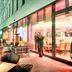 Leonardo Hotel Munich City South terrace with outdoor seating and lit restaurant interior in Munich