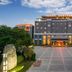 Liuhu Hotel (Hot Spring Garden Hotel) in Dezhou, exterior with illuminated entrance and plaza