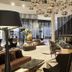 Hilton Tallinn Park lobby bar in Tallinn with modern seating and a sleek illuminated counter