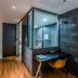 Rivertain Hotel Daegu compact room with desk and glass-enclosed shower
