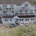 Fletcher Badhotel Egmond aan Zee exterior with balconies and seaside grass in foreground