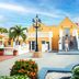Amsterdam Manor Beach Resort in Noord with yellow villas, palm landscaping, and a staircase entry