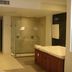 In Fashion Hotel & Spa in Playa del Carmen bathroom with glass shower and wood vanity
