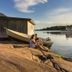 Käringsund Resort in Eckerö: guests sit by a calm waterfront with boats at sunset