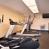 Days Inn by Wyndham Culpeper fitness room with treadmills, elliptical, wall clock, TV and water fountain
