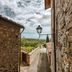 Villa Di Sotto in Castelnuovo Berardenga, stone alleyway with countryside view and lantern