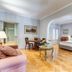 Rome Frattina 27 in Rome: spacious suite with bed, seating area, coffee station, and arched doorway