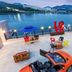 Onda D'oro Hostel in Yeosu rooftop terrace with ocean view, lounge chairs, umbrellas and red LOVE sculpture