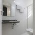 Paulista Garden Hotel bathroom with wall mirror, granite sink, towel rack and toilet in Sao Paulo
