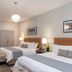 Broadway Plaza Hotel in New York guest room with two beds, modern lighting and dresser