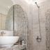 Hotel Lodos in Karterados bathroom with shower and mosaic-tiled arched niches beside a vessel sink