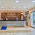 Howard Johnson by Wyndham Barranquilla Versalles lobby with reception desk and staircase in Barranquilla