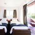 Haka House Taupo twin room with balcony doors and window seat in Taupo