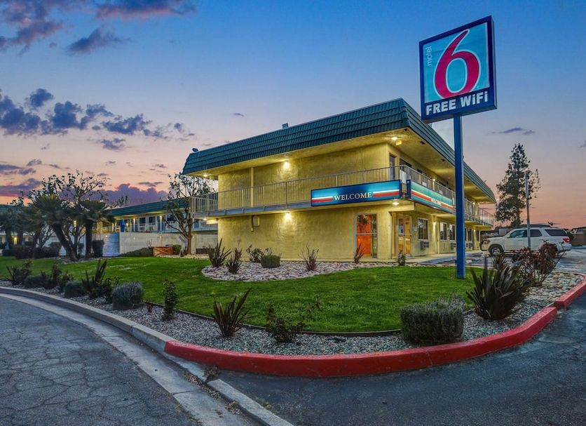 Motel 6 King City Ca exterior at dusk with free WiFi sign and landscaped entrance