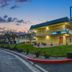 Motel 6 King City Ca exterior at dusk with free WiFi sign and landscaped entrance