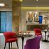 Fh55 Grand Hotel Mediterraneo in Florence lounge bar with colorful chairs and cocktail tables