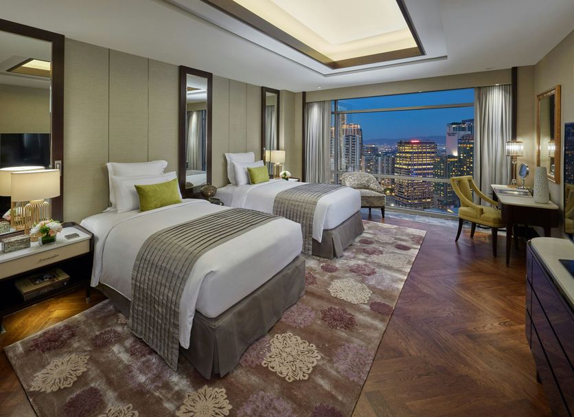 Mandarin Oriental, Kuala Lumpur guest room with twin beds and city skyline view
