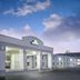 Days Inn Roanoke Near I-81 exterior with covered entrance and motel rooms under a blue sky
